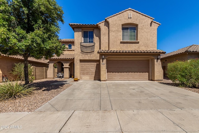 6084 W Yorktown Way, Florence, AZ 85132 - mediterranean / spanish-style home with stucco siding, an attached garage, driveway, and a tile roof