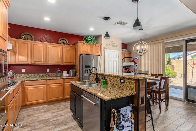 6084 W Yorktown Way, Florence, AZ 85132 - kitchen with visible vents, a sink, light wood-style flooring, and appliances with stainless steel finishes