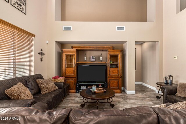 6084 W Yorktown Way, Florence, AZ 85132 - living area featuring visible vents, a high ceiling, and wood finished floors