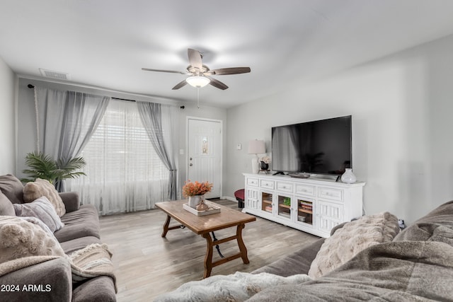 living room with hardwood / wood-style flooring and ceiling fan