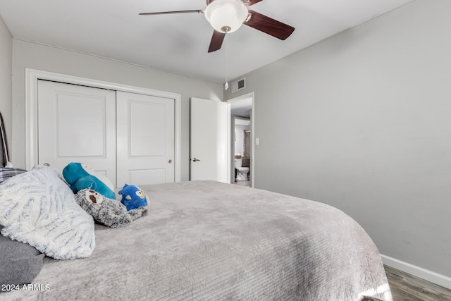 bedroom with a closet, hardwood / wood-style flooring, and ceiling fan