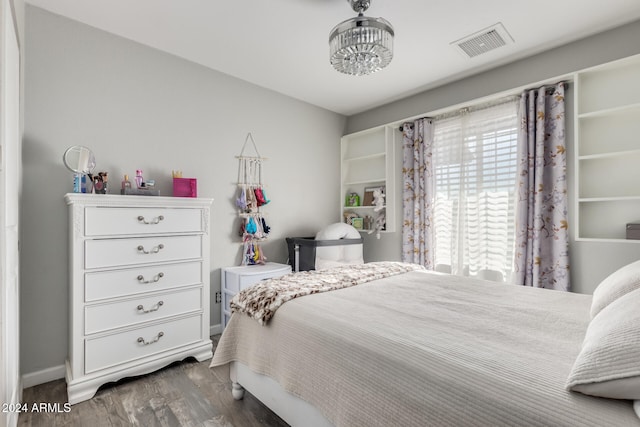 bedroom with dark wood-type flooring