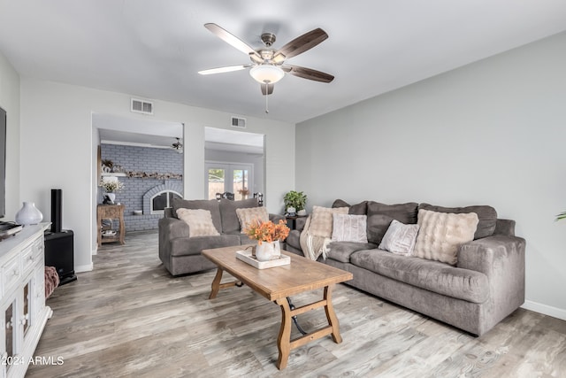 living room with ceiling fan, light hardwood / wood-style floors, and french doors