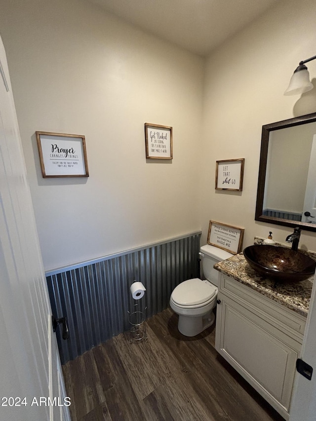 bathroom featuring vanity, hardwood / wood-style floors, and toilet