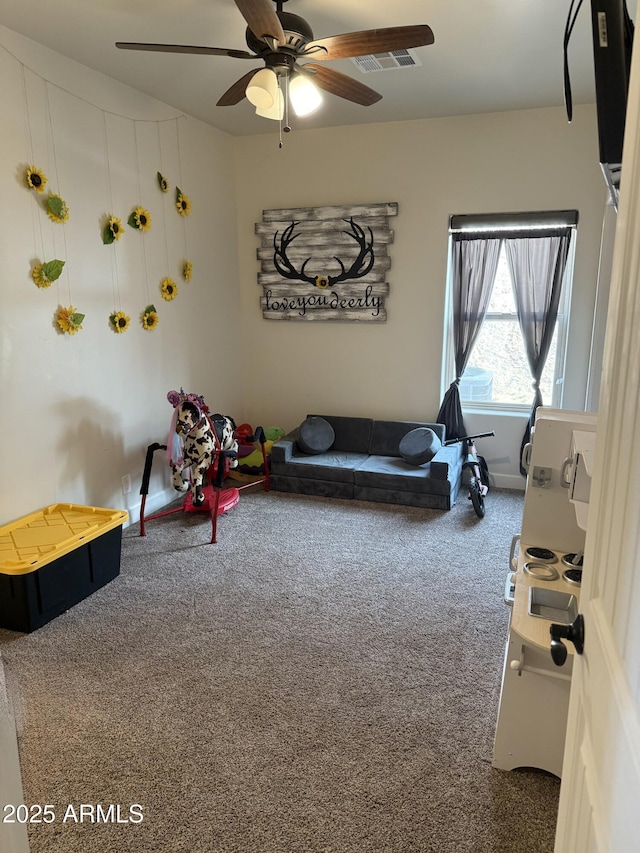 interior space with ceiling fan and carpet floors