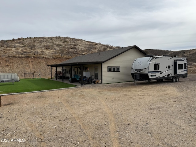 exterior space featuring a carport and a front yard