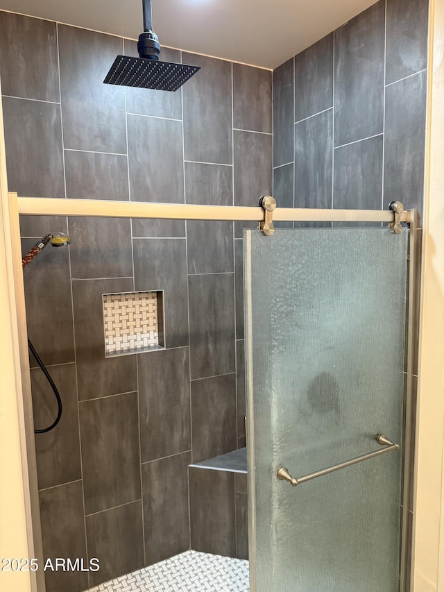 bathroom featuring a shower with shower door