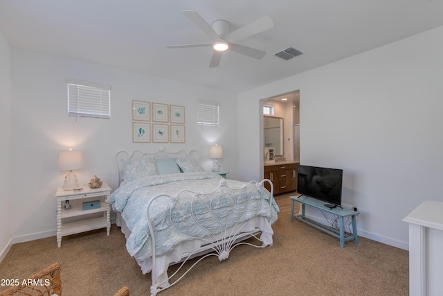 bedroom featuring carpet floors, ensuite bathroom, and ceiling fan