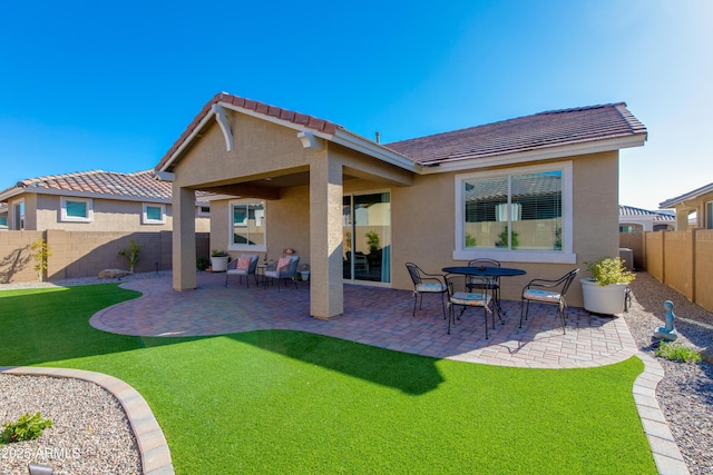 back of house featuring a patio and a lawn