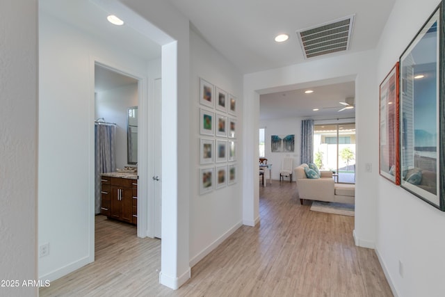 corridor with light hardwood / wood-style flooring