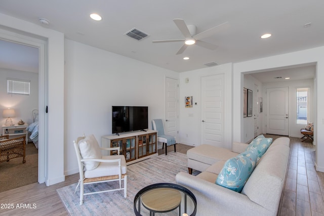 living room with ceiling fan and light hardwood / wood-style floors