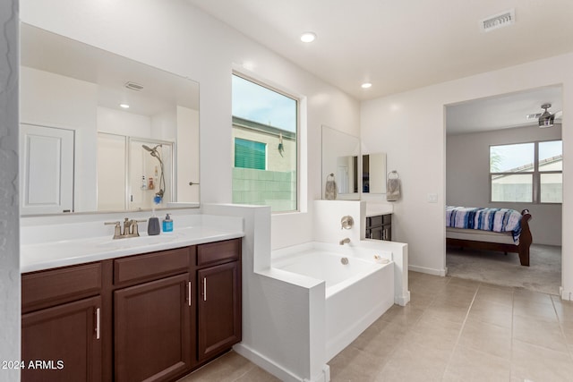 bathroom featuring tile patterned flooring, separate shower and tub, and vanity