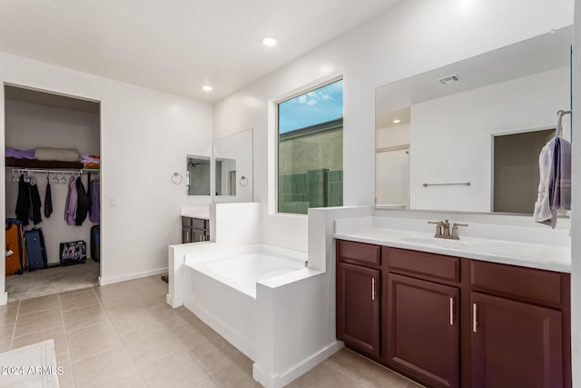 bathroom with tile patterned flooring, vanity, and independent shower and bath