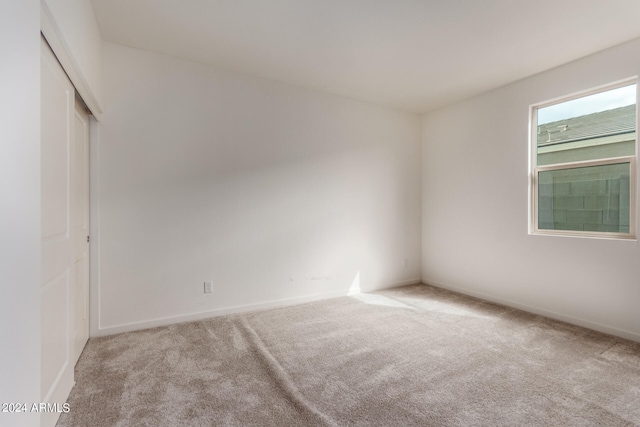 empty room featuring light carpet