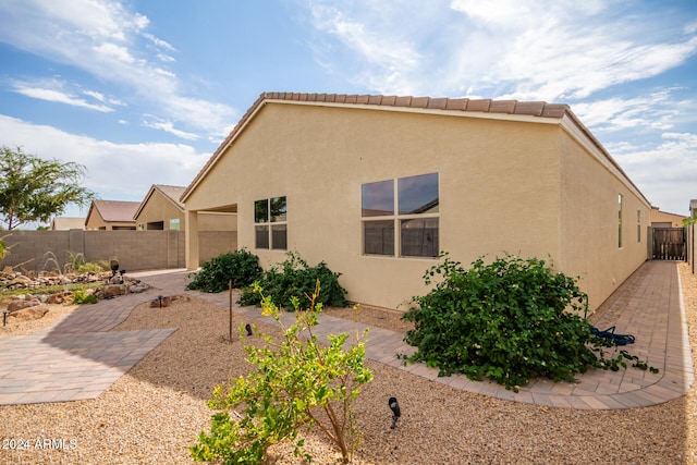 rear view of property featuring a patio