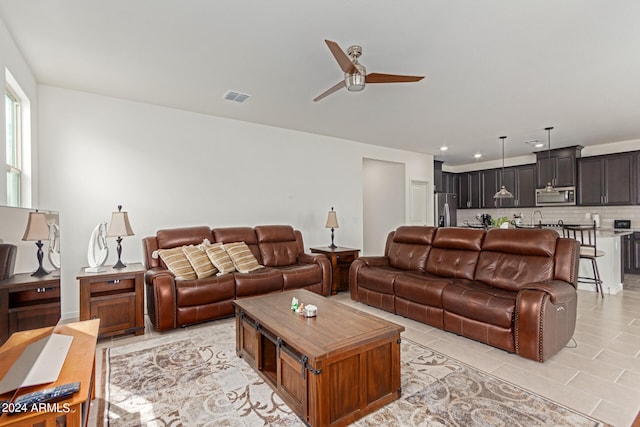 tiled living room featuring ceiling fan