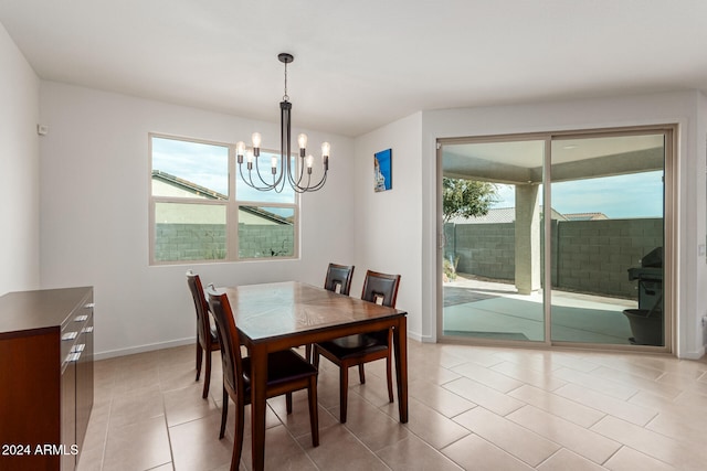 dining area with an inviting chandelier and light tile patterned flooring