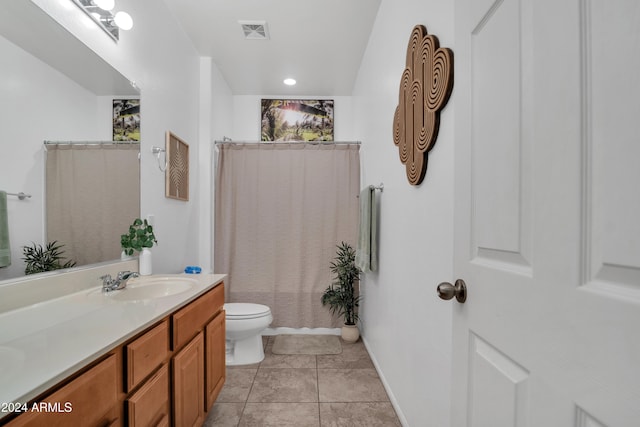 bathroom featuring vanity, toilet, tile patterned floors, and a shower with curtain