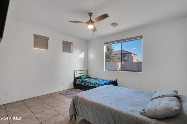 bedroom with light tile patterned floors and ceiling fan