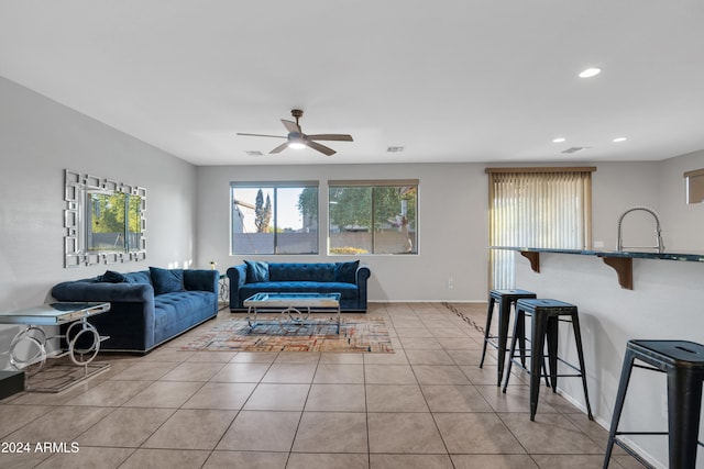 living room with light tile patterned flooring and ceiling fan