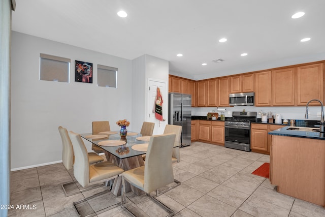 kitchen with sink, stainless steel appliances, and light tile patterned floors