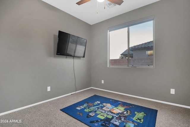 playroom with ceiling fan and carpet flooring