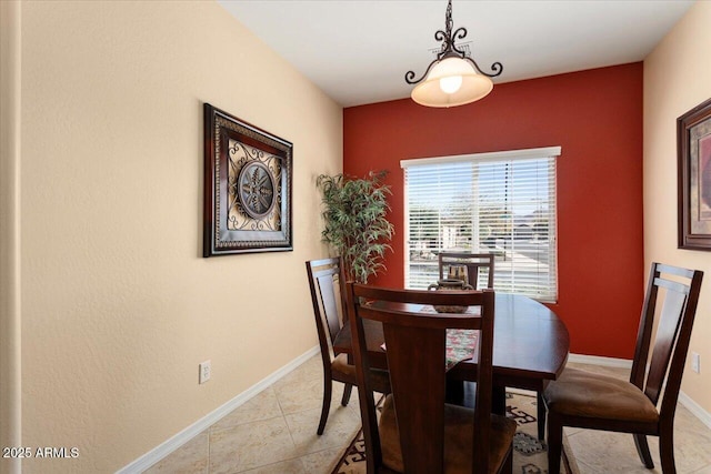 dining room with baseboards and light tile patterned floors