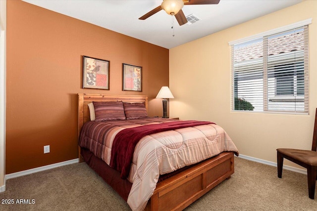 bedroom with light colored carpet, ceiling fan, visible vents, and baseboards