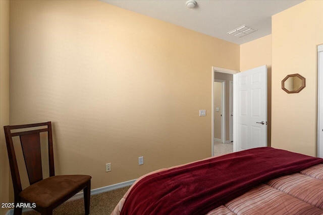 carpeted bedroom with visible vents and baseboards