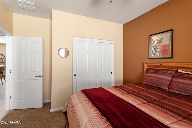 bedroom with a closet, light colored carpet, visible vents, and baseboards