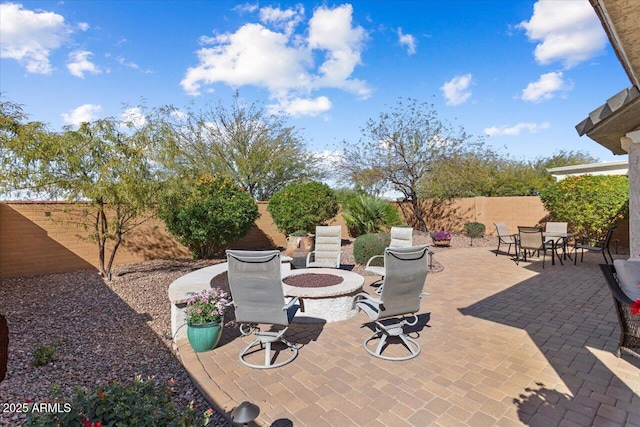 view of patio / terrace with an outdoor fire pit, outdoor dining area, and a fenced backyard