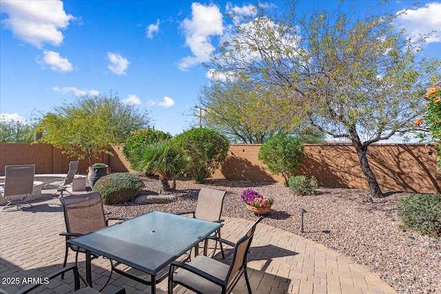 view of patio featuring outdoor dining space and a fenced backyard