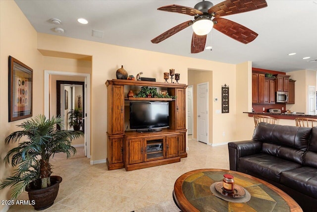 living area featuring light tile patterned floors, ceiling fan, recessed lighting, and baseboards