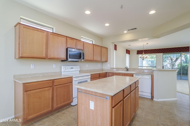 kitchen with pendant lighting, a chandelier, a center island, white appliances, and light tile patterned floors