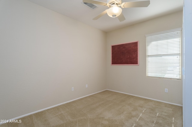 carpeted empty room featuring ceiling fan