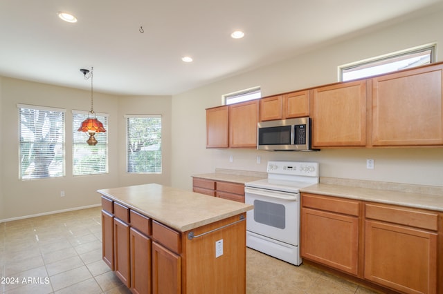 kitchen with light tile patterned floors, pendant lighting, white electric stove, and a center island