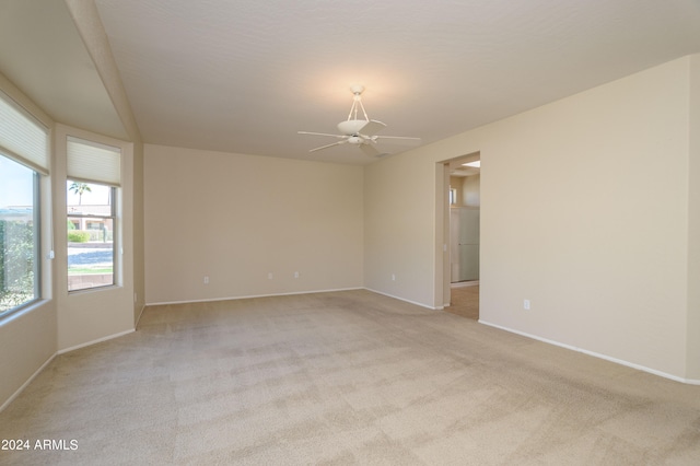 empty room with ceiling fan and light colored carpet