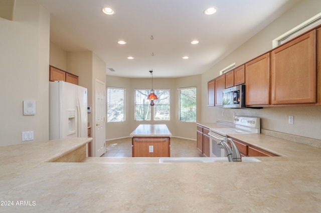 kitchen featuring hanging light fixtures, white appliances, light tile patterned floors, a center island, and sink