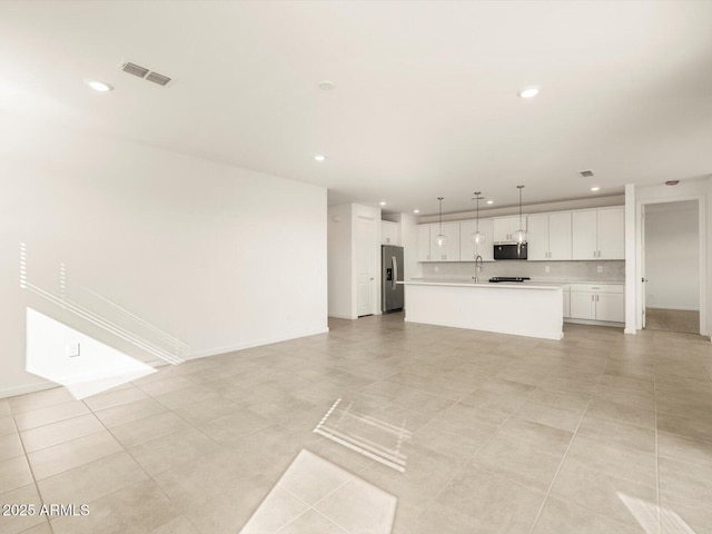 unfurnished living room featuring light tile patterned flooring and sink