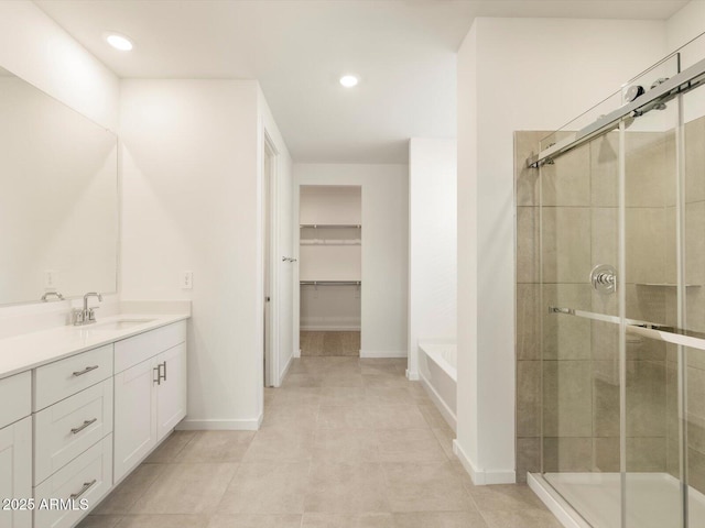 bathroom featuring vanity and separate shower and tub