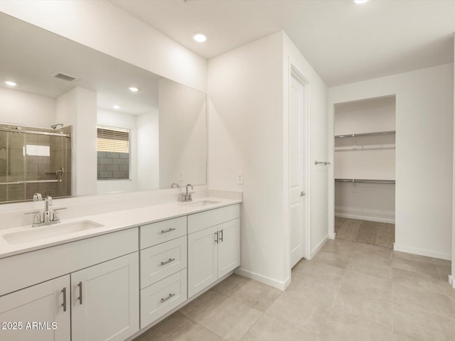 bathroom featuring an enclosed shower, vanity, and tile patterned floors