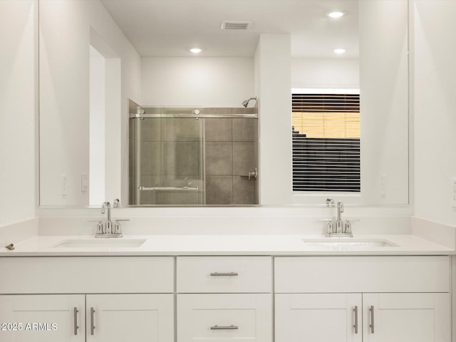 bathroom featuring vanity and an enclosed shower