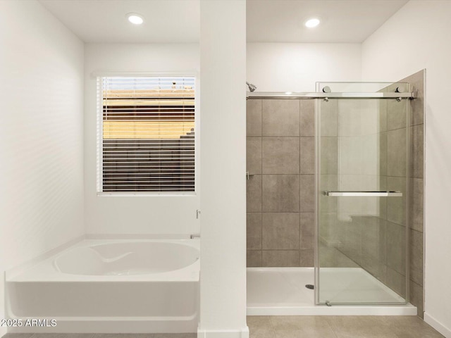 bathroom featuring shower with separate bathtub and tile patterned flooring