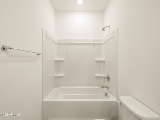 bathroom with shower / washtub combination and toilet