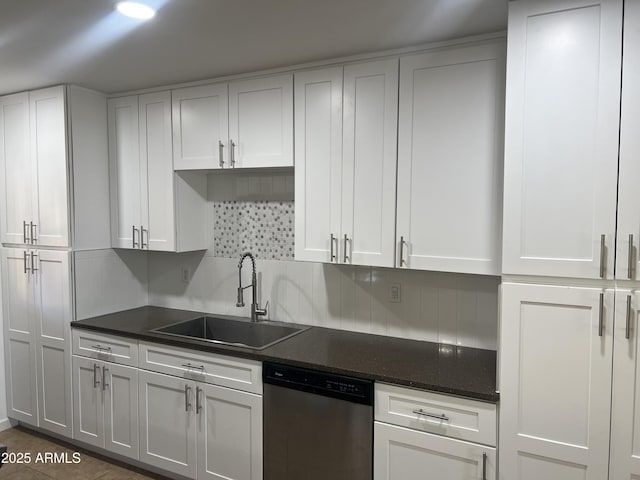 kitchen featuring sink, dishwasher, dark tile patterned flooring, decorative backsplash, and white cabinets