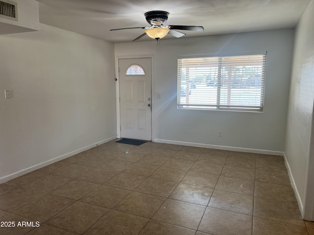 tiled foyer featuring ceiling fan