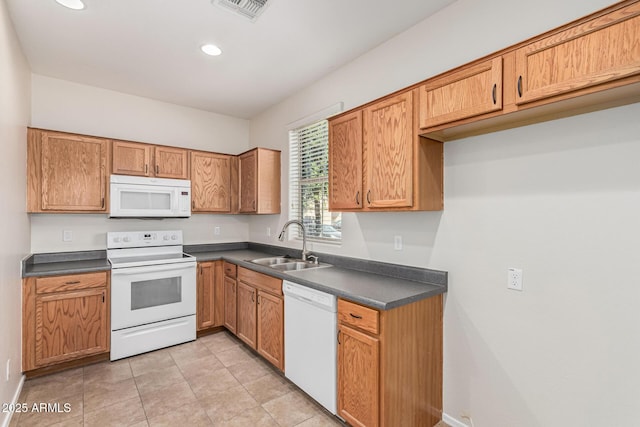 kitchen featuring sink, white appliances, and light tile patterned floors