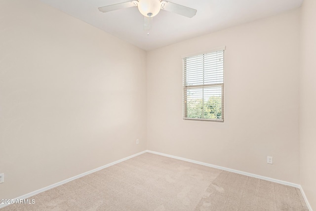 spare room featuring ceiling fan and light carpet