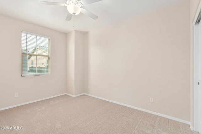 spare room with light colored carpet and ceiling fan