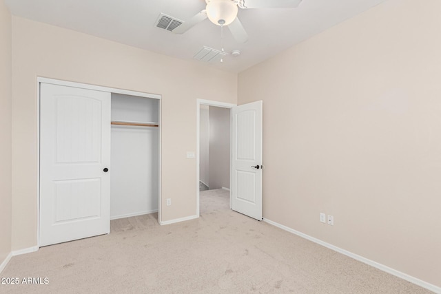 unfurnished bedroom with light colored carpet, ceiling fan, and a closet